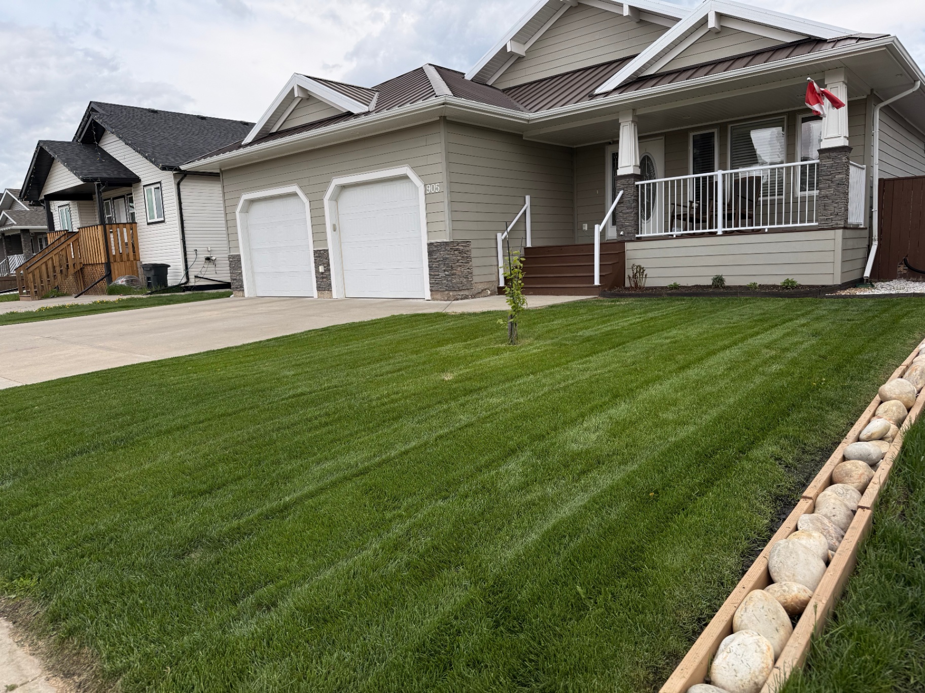 Premium striped front lawn after professional mowing
